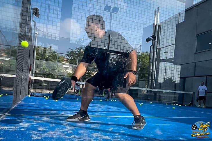 Experience the impressive off-the-wall backhand moves by a Surinamese Padel player at the Padel Camp Vacation in Spain, showcasing Asics and Nike gear.