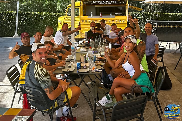 Ecstatic Padel participants, hailing from The Netherlands, Suriname, China, Spain, Catalunya, Kuwait, take a joyful break during the international Padel Clinic in Maresme, Barcelona, Spain.