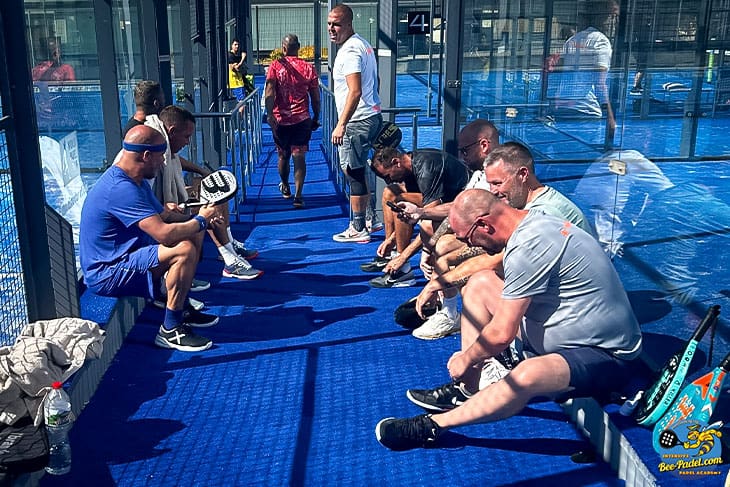 Joyful Padel participants from around the globe take a break and relax during a refreshing pause at the international Padel Clinic.
