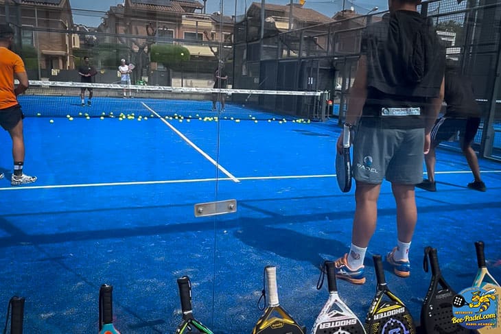 Padel match with two padel coaches, Sergi Rodriguez Fernandez and Jaume Pons coaching to players from Saudi Arabia during the Intensive Padel Clinic racket for testing on foreground