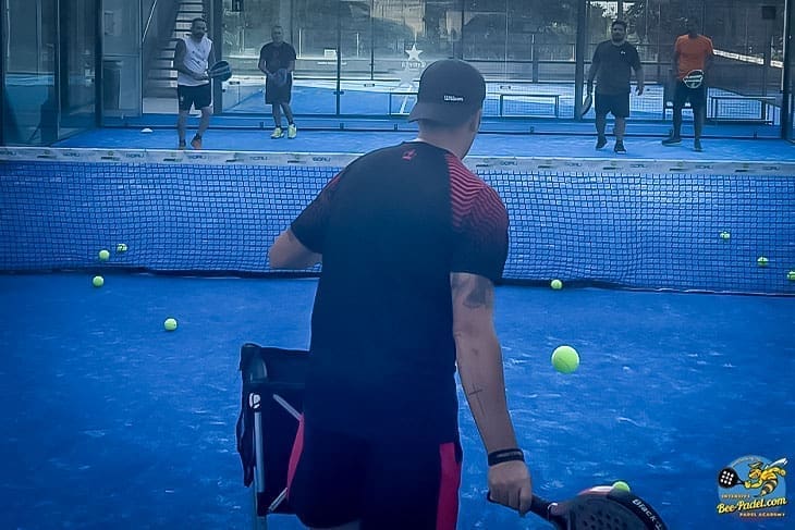 Padel trainer trowing balls for mixed levels how to attack the net