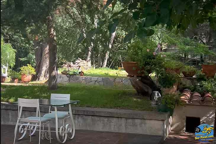 Garden breakfast terrace at Masia Can Casadellà surrounded by tropical flowers and lush greenery