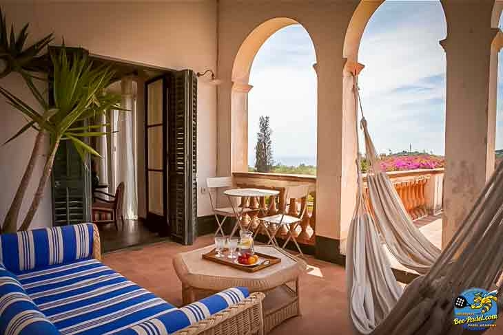Shaded terrace hammock at Masia Can Casadellà, ideal for silent retreat moments and relaxing after a padel clinic