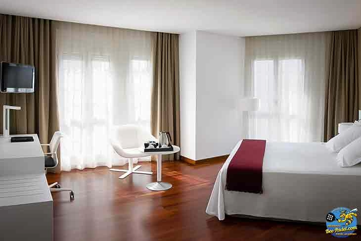 Spacious double room with large windows and basic amenities at URH Hotel Mataró, a budget-friendly hotel near the beach and padel courts.