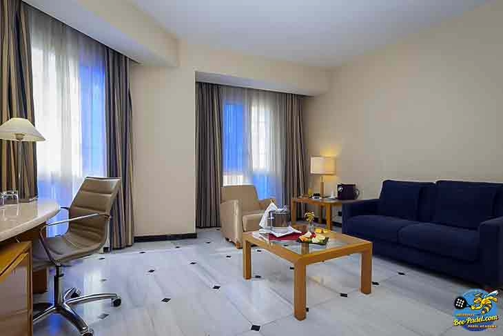 Spacious room with separate seating area at URH Hotel Mataró, a 2-star budget hotel near the beach and 10 minutes from padel courts.