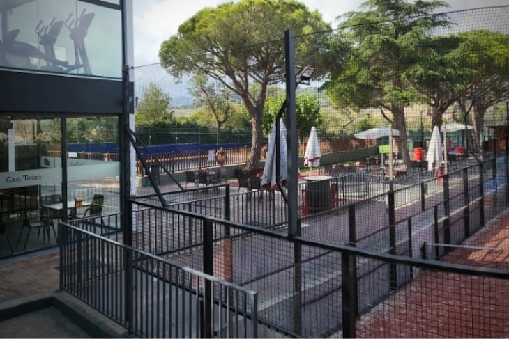 Scenic view from the terrace at Can Teixidó Padel Club overlooking the padel courts and surrounding Mediterranean landscape.