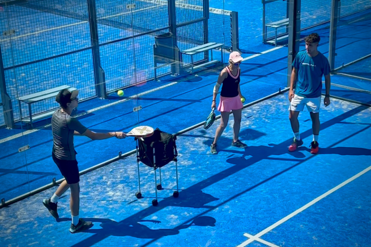 Padel trainer coaching Angolan clients during an intensive padel clinic at SorliSport Vilassar de Dalt near Barcelona